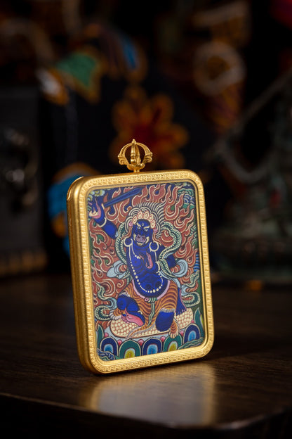 AURESTAR Acalanatha thangka pendant displayed upright on a wooden table.