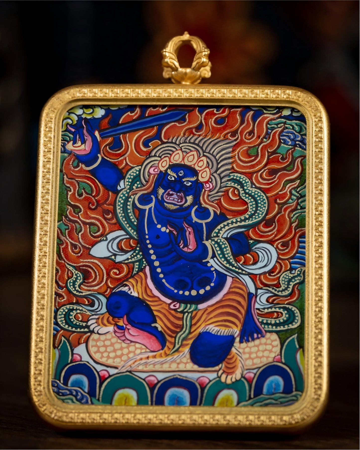 Front close-up of AURESTAR Acalanatha thangka pendant with painted Buddhist artwork.