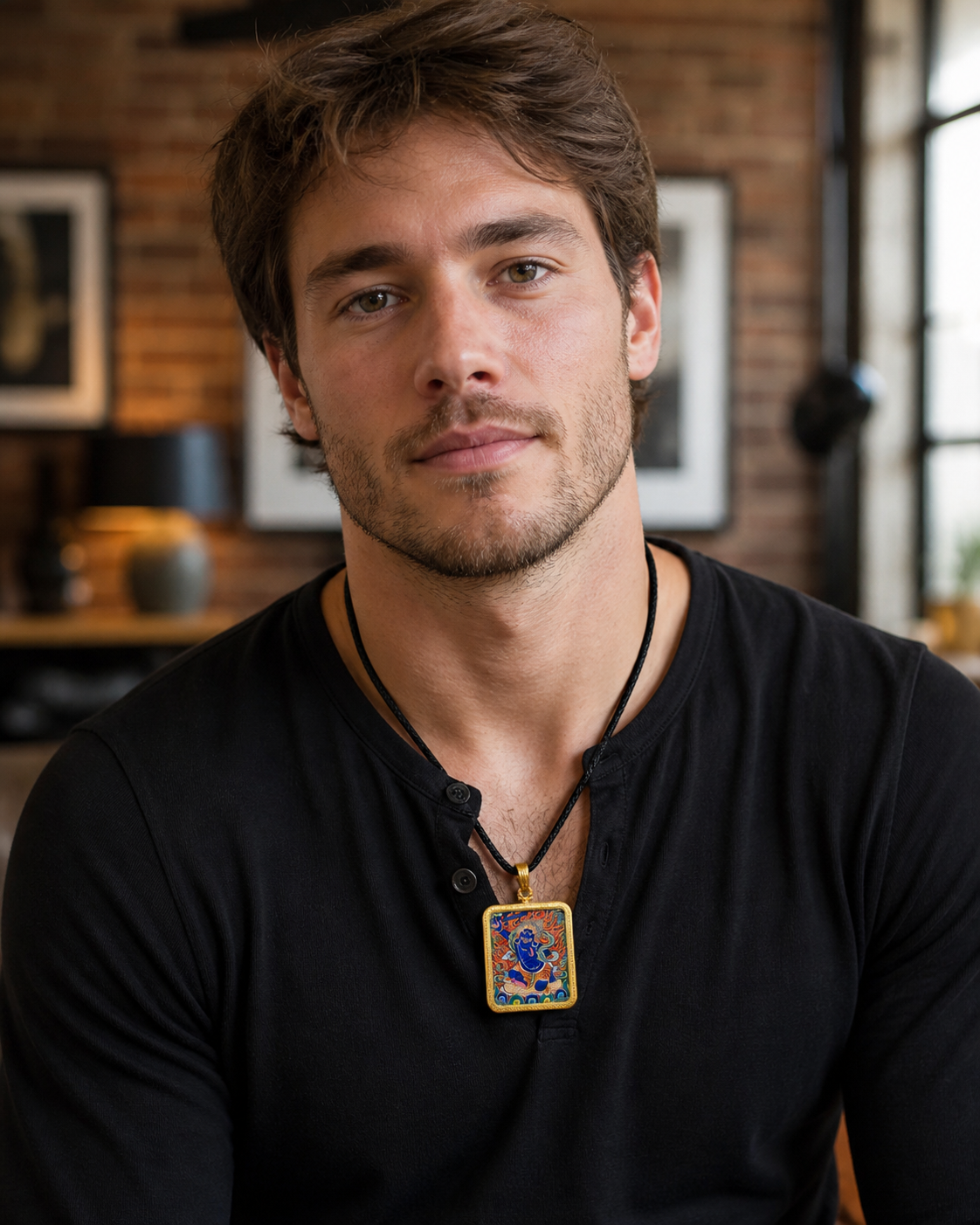 Man wearing an AURESTAR Acalanatha thangka pendant with a black shirt.