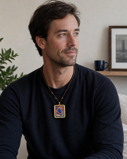Man wearing an AURESTAR Acalanatha thangka pendant with a gray shirt.