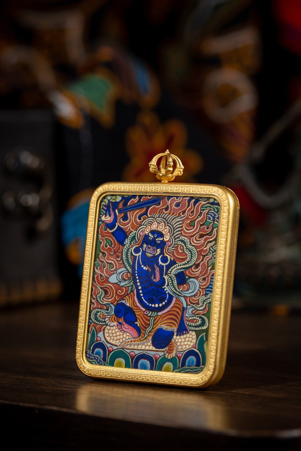 Side view of AURESTAR Acalanatha thangka pendant in a copper case.