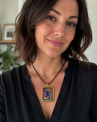 Woman wearing an AURESTAR Buddhist thangka pendant with a black top.