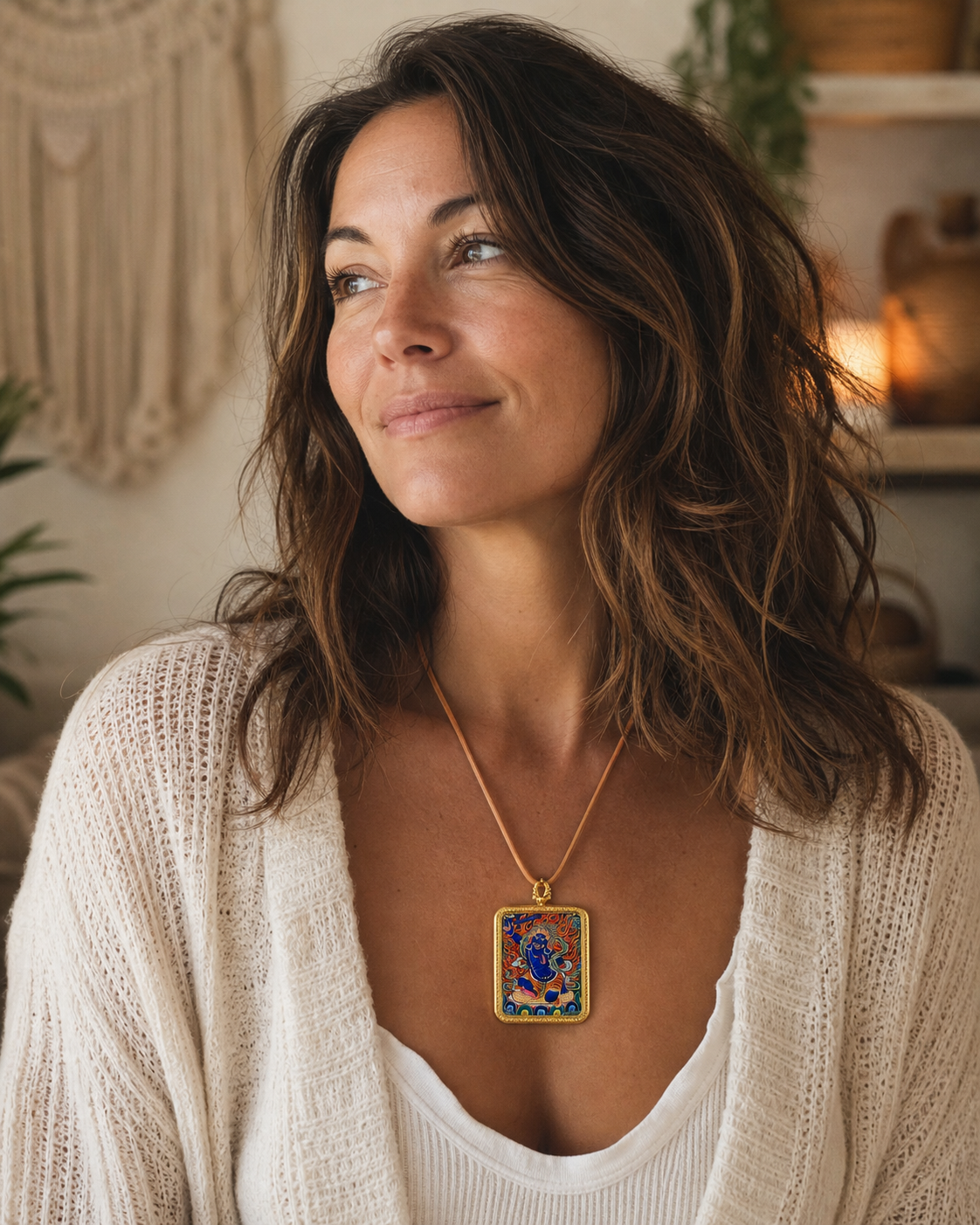 Woman wearing an AURESTAR Acalanatha thangka pendant in a home setting.