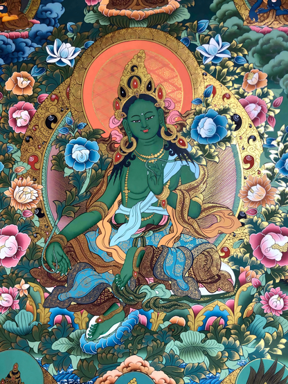 Close-up of Green Tara figure in a detailed Tibetan thangka painting.
