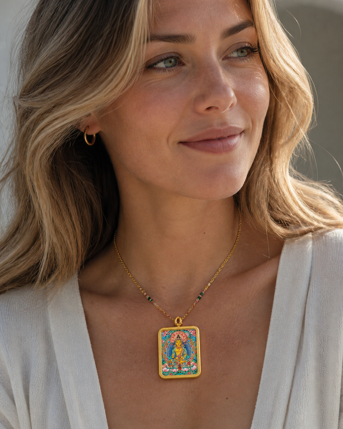 Close-up of woman wearing an AURESTAR Ksitigarbha thangka pendant.