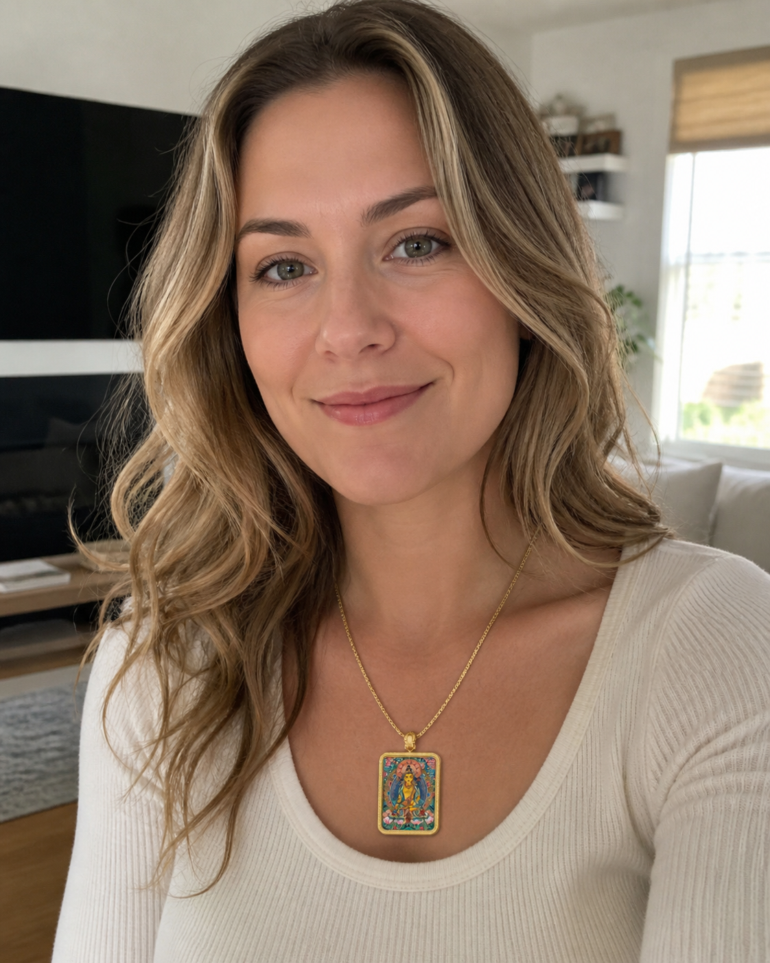 Woman wearing an AURESTAR Ksitigarbha thangka pendant with a white top.