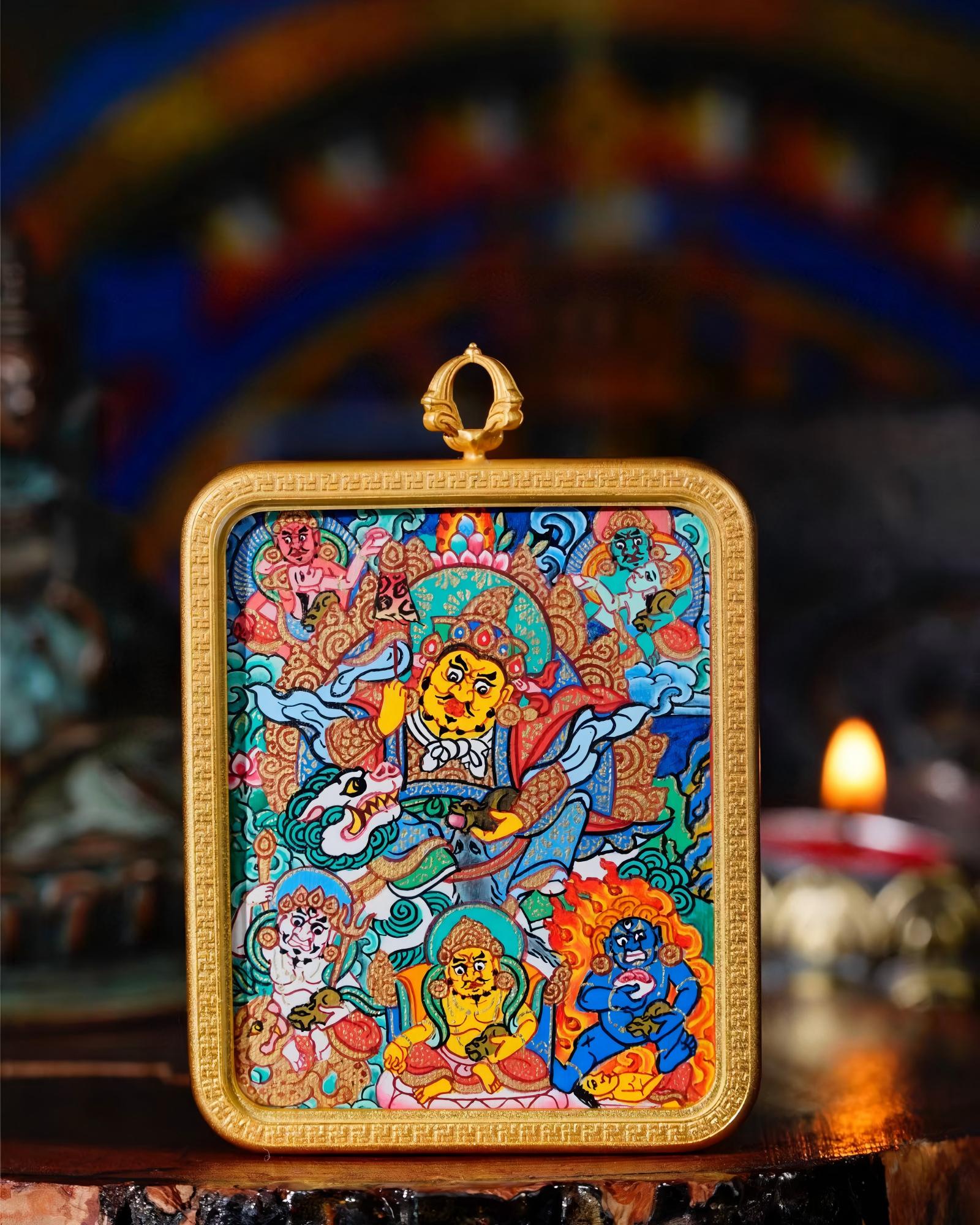 Close-up of a Vaishravana thangka pendant with a gold-toned copper case.