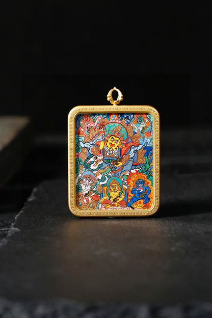 Vaishravana thangka pendant displayed upright against a dark background.