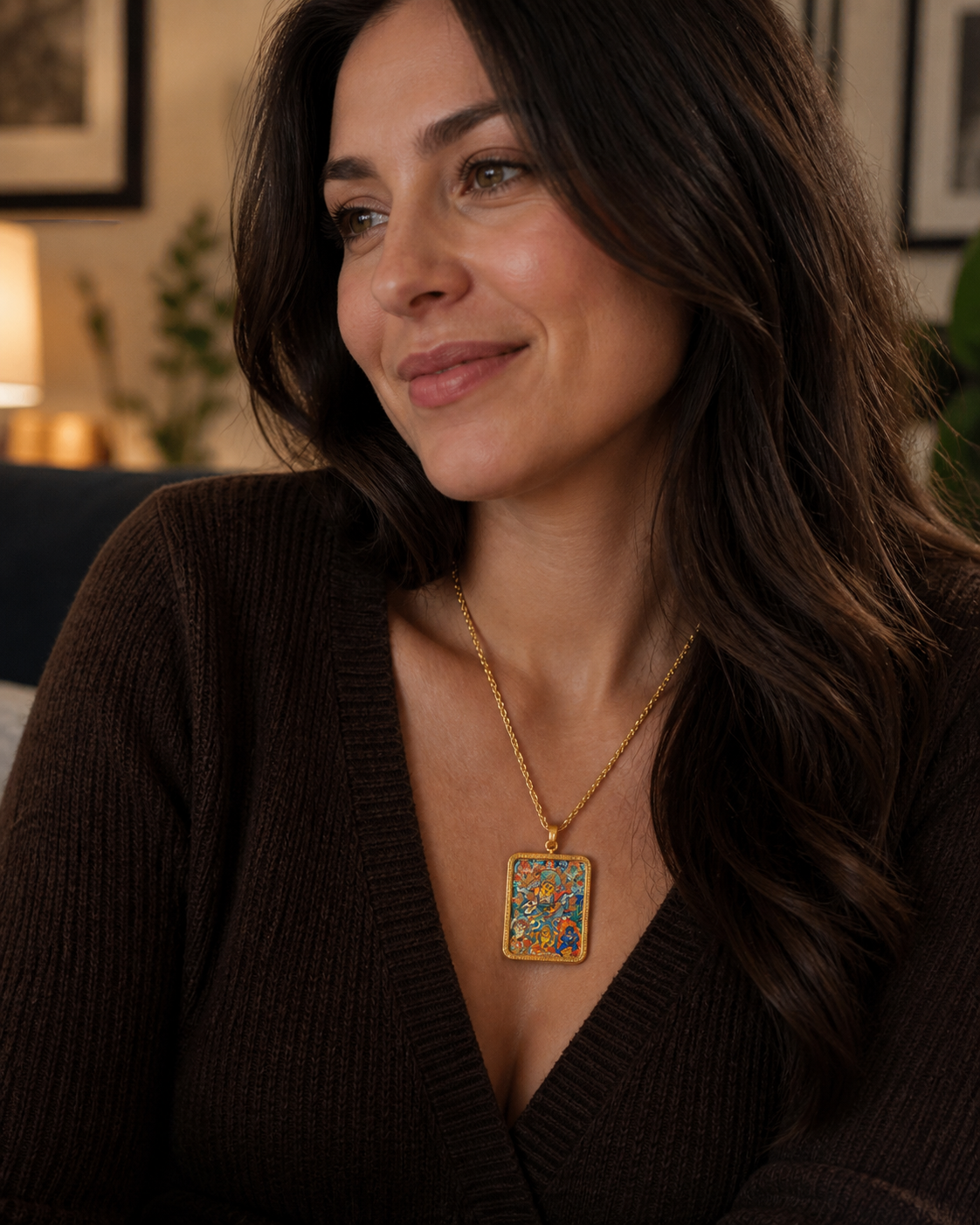 Woman wearing an AURESTAR Buddhist thangka pendant with a brown sweater.